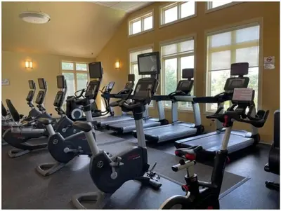a gym with a bunch of exercise bikes in a room at Luxury Spacious Home with some FREE Amenities and Activities! in Mushroom Farms