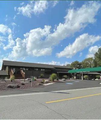 a building with a green roof on the side of a road at Luxury Spacious Home with some FREE Amenities and Activities! in Mushroom Farms