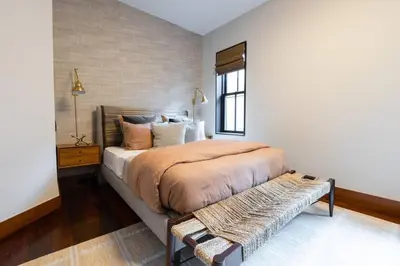 a bedroom with a large bed and a window at E10-3 3BR Designer Townhouse in New York