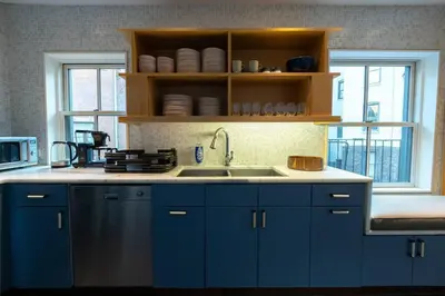 a kitchen with blue cabinets and a sink at E10-3 3BR Designer Townhouse in New York