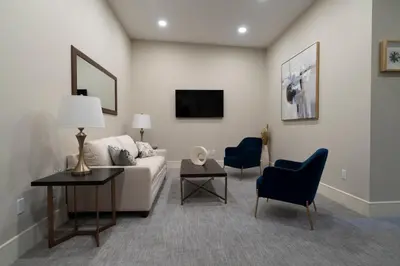 a living room with a couch and a table and chairs at Orange Inn Boutique Hotel in Goshen