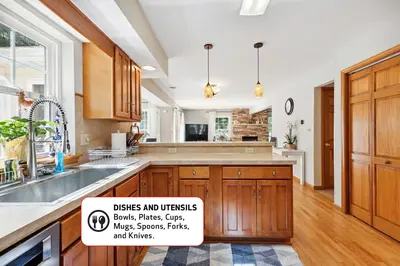 a large kitchen with wooden cabinets and a sign in it at Spacious Home by Kalahari Waterpark, Camelback, Jim Thorpe, FREE EV and PRIVATE SAUNA in Albrightsville
