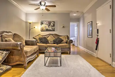 a living room with two couches and a table at Hoboken Condo Walk to Public Transit! in Hoboken