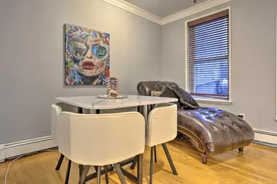 a living room with a table and a couch at Hoboken Condo Walk to Public Transit! in Hoboken
