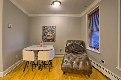 a dining room with a table and a chair at Hoboken Condo Walk to Public Transit! in Hoboken