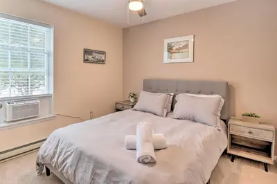 a bedroom with a large bed and a window at Gas Grill, Lake Access Scenic Poconos Retreat! in East Stroudsburg