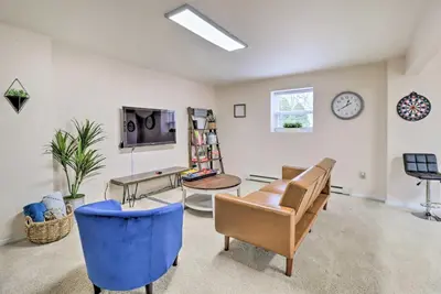 a living room filled with furniture and a tv at Gas Grill, Lake Access Scenic Poconos Retreat! in East Stroudsburg