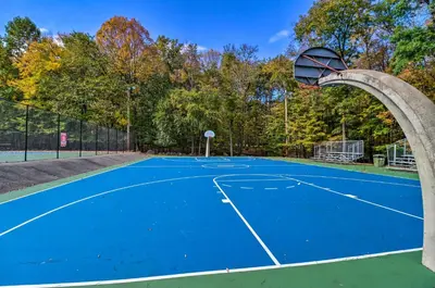 a basketball hoop on a tennis court at Gas Grill, Lake Access Scenic Poconos Retreat! in East Stroudsburg