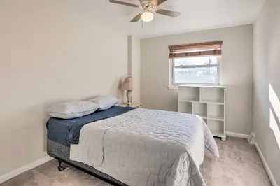 a bedroom with a bed and a ceiling fan at Cozy Townhome about 12 Mi to Downtown Philly!