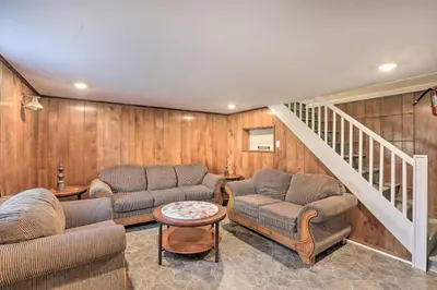 a living room with two couches and a staircase at Cozy Townhome about 12 Mi to Downtown Philly!