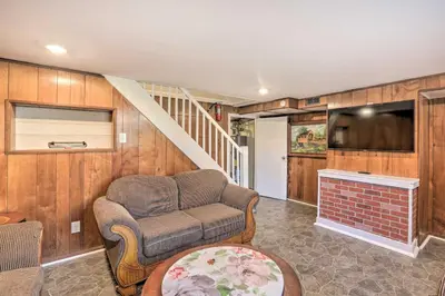 a living room with a couch and a tv at Cozy Townhome about 12 Mi to Downtown Philly!
