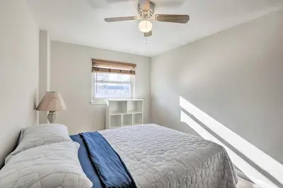 a bedroom with a bed and a ceiling fan at Cozy Townhome about 12 Mi to Downtown Philly!