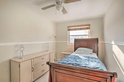 a bedroom with a bed and a ceiling fan at Cozy Townhome about 12 Mi to Downtown Philly!
