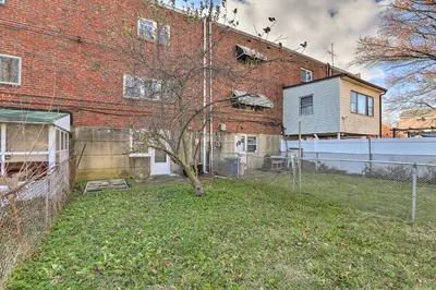 a brick building with a tree in the yard at Cozy Townhome about 12 Mi to Downtown Philly!