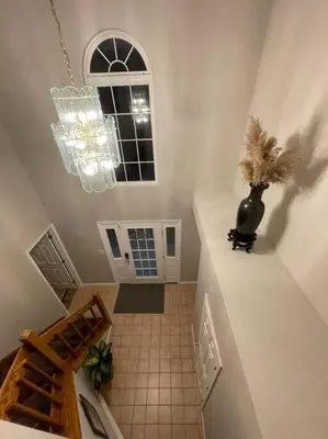 a hallway with a vase on the wall and a staircase at Quiet Private House w Hot Tub/Fire pit/Games in Blakeslee