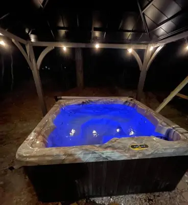 a large blue tub in a room with lights at Quiet Private House w Hot Tub/Fire pit/Games in Blakeslee