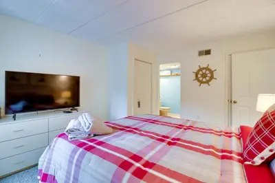 a bedroom with a bed and a flat screen tv at Game Room and BBQ Waterfront Lake Harmony Condo! in Lake Harmony