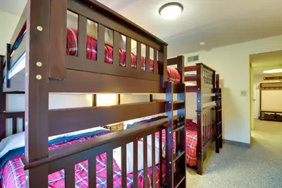 two sets of bunk beds in a room at Game Room and BBQ Waterfront Lake Harmony Condo! in Lake Harmony