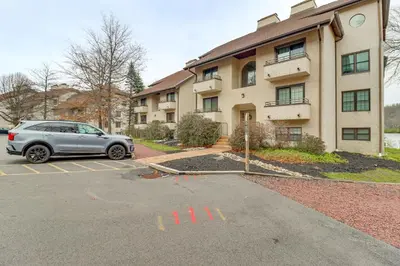 a car parked in a parking lot in front of a building at Game Room and BBQ Waterfront Lake Harmony Condo! in Lake Harmony