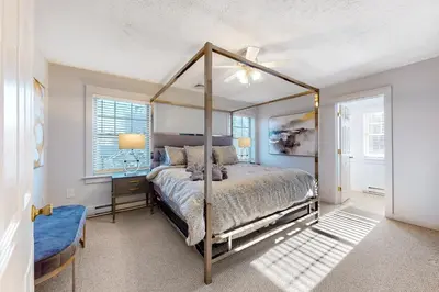 a bedroom with a canopy bed and a window at Modern Mountain in Tannersville