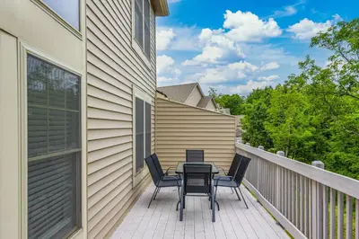a patio with a table and chairs on a balcony at Modern Mountain in Tannersville