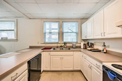 a kitchen with white cabinets and a sink at Lancaster Unit with Expansive Covered Porch! in Lancaster