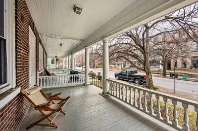 a rocking chair on the porch of a house at Lancaster Unit with Expansive Covered Porch! in Lancaster