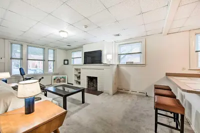 a living room with a fireplace and a tv at Lancaster Unit with Expansive Covered Porch! in Lancaster