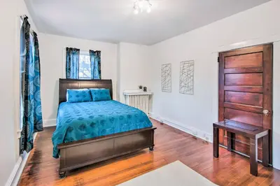a bedroom with a bed and a wooden door at Roomy Lancaster Home Walk to Dtwn and Hospital in Lancaster