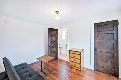 a living room with a couch and a table and a door at Roomy Lancaster Home Walk to Dtwn and Hospital in Lancaster