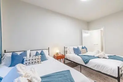 two beds in a room with blue and white at Blue Breakaway with Free Parking and Sleeps 9, Book 7 days, Get 20 Percent OFF in East Orange