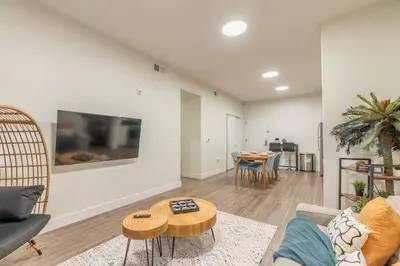 a living room with a couch and a table at Blue Breakaway with Free Parking and Sleeps 9, Book 7 days, Get 20 Percent OFF in East Orange