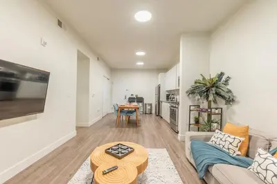 a living room with a couch and a table at Blue Breakaway with Free Parking and Sleeps 9, Book 7 days, Get 20 Percent OFF in East Orange