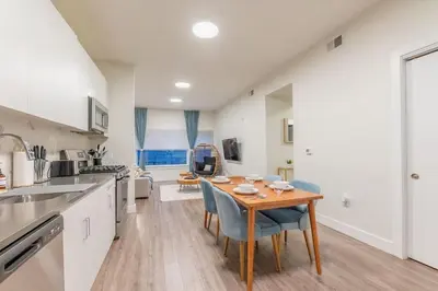 a kitchen and dining room with a table and chairs at Blue Breakaway with Free Parking and Sleeps 9, Book 7 days, Get 20 Percent OFF in East Orange