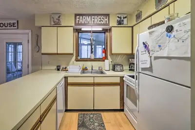 a kitchen with a white refrigerator and a sink at Walk to Locust Lake Poconos Vacation Home! in Pocono Lake