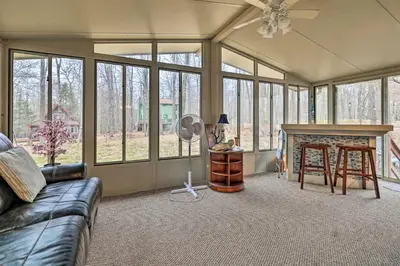 a living room with a couch and a fireplace at Walk to Locust Lake Poconos Vacation Home! in Pocono Lake