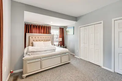 a bedroom with a bed and a window and a door at Updated Linden Home Visit NYC and Newark! in Linden
