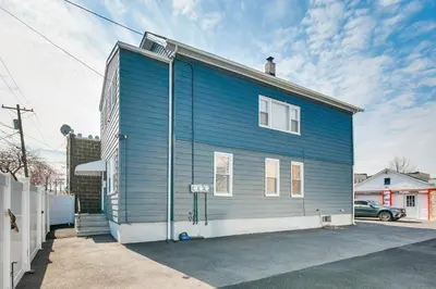 a blue house with a man on top of it at Updated Linden Home Visit NYC and Newark! in Linden