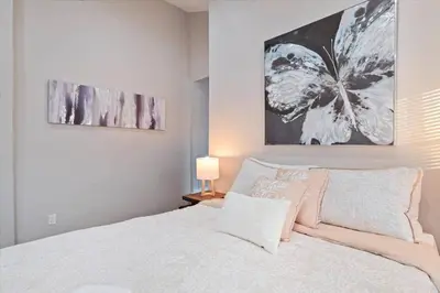 a bedroom with a bed and a painting on the wall at Newly Built 2 Bdrm-By Philly Center City in Philadelphia