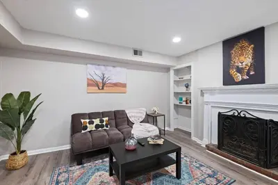 a living room with a couch and a fireplace at Newly Built 2 Bdrm-By Philly Center City in Philadelphia