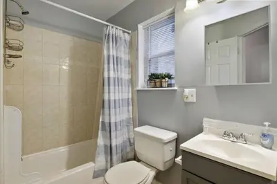 a bathroom with a toilet and a sink and a shower at Newly Built 2 Bdrm-By Philly Center City in Philadelphia