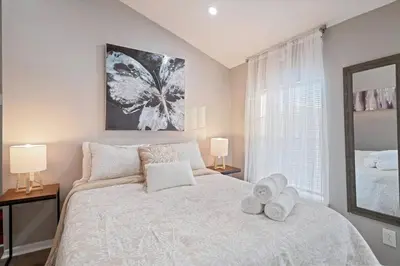 a bedroom with a white bed with towels on it at Newly Built 2 Bdrm-By Philly Center City in Philadelphia