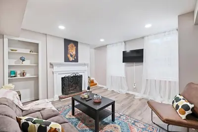 a living room with a couch and a fireplace at Newly Built 2 Bdrm-By Philly Center City in Philadelphia