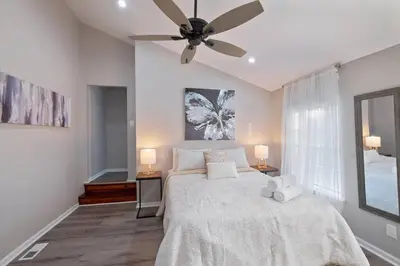 a bedroom with a large bed with a ceiling fan at Newly Built 2 Bdrm-By Philly Center City in Philadelphia