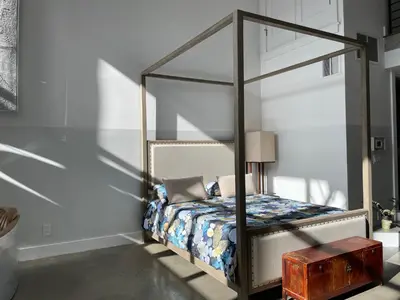 a bedroom with a bed with a glass canopy at Duplex Suite in Art Tower in Philadelphia