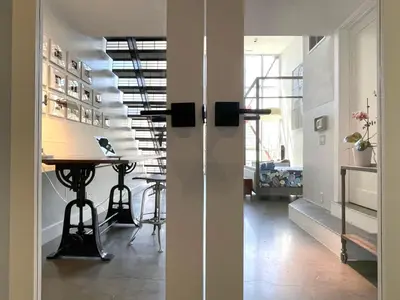 a hallway with a table and a staircase in a room at Duplex Suite in Art Tower in Philadelphia