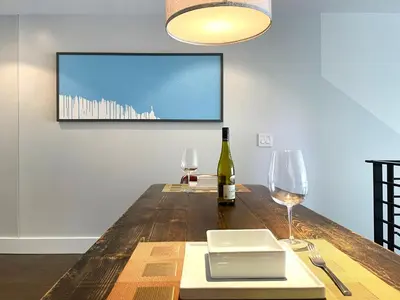 a table with a bottle of wine and two glasses at Duplex Suite in Art Tower in Philadelphia