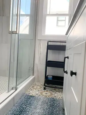 a bathroom with a walk in shower and a ladder at Newly renovated 4 bedroom apartment near downtown. in Montclair