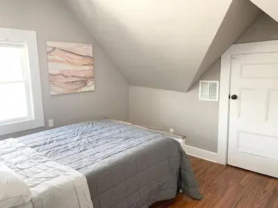 a bedroom with a large bed in a attic at Newly renovated 4 bedroom apartment near downtown. in Montclair