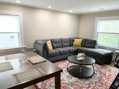 a living room with a couch and a table at Newly renovated 4 bedroom apartment near downtown. in Montclair